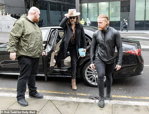 Russell Brand: From Comedian to Defendant, Bible in Hand as He Faces Criminal Charges